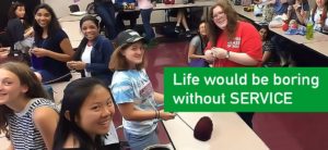 Students helping in a classroom. Caption reads life would be boring without service