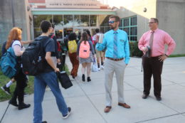 Assistant Director and Director observe student arrival to school