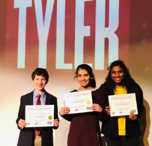 3 students holding certificate awards