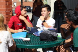 Students outside at table