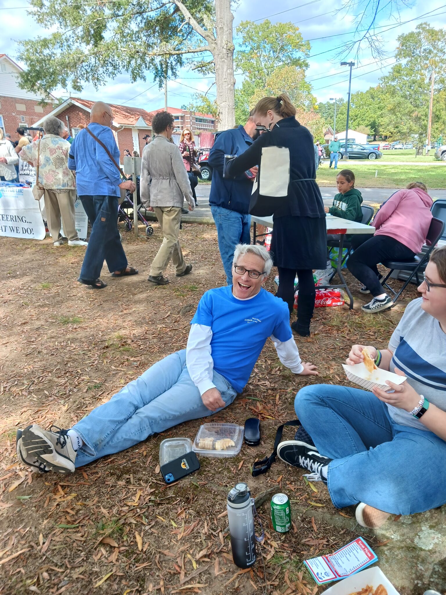 Teacher sitting on the ground with food