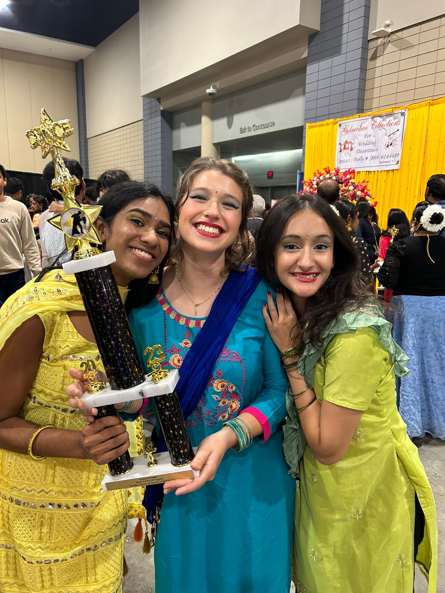 3 female students holding trophy